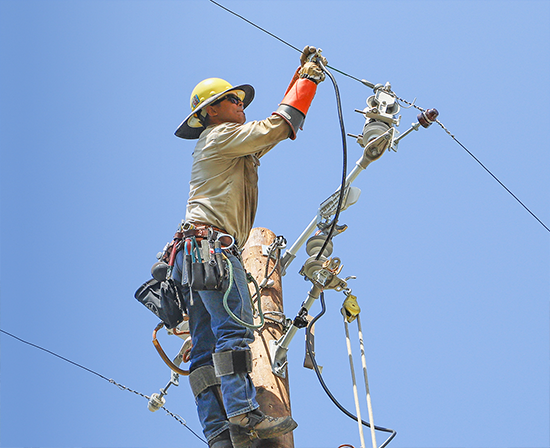 Image of a lineman on a power pole making an electric repair.