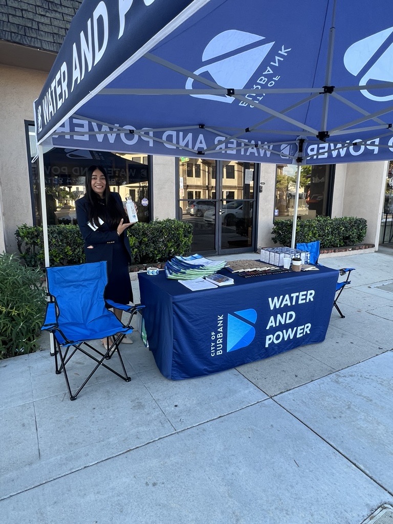Mandip holding a water bottle outside the Ugly Mug