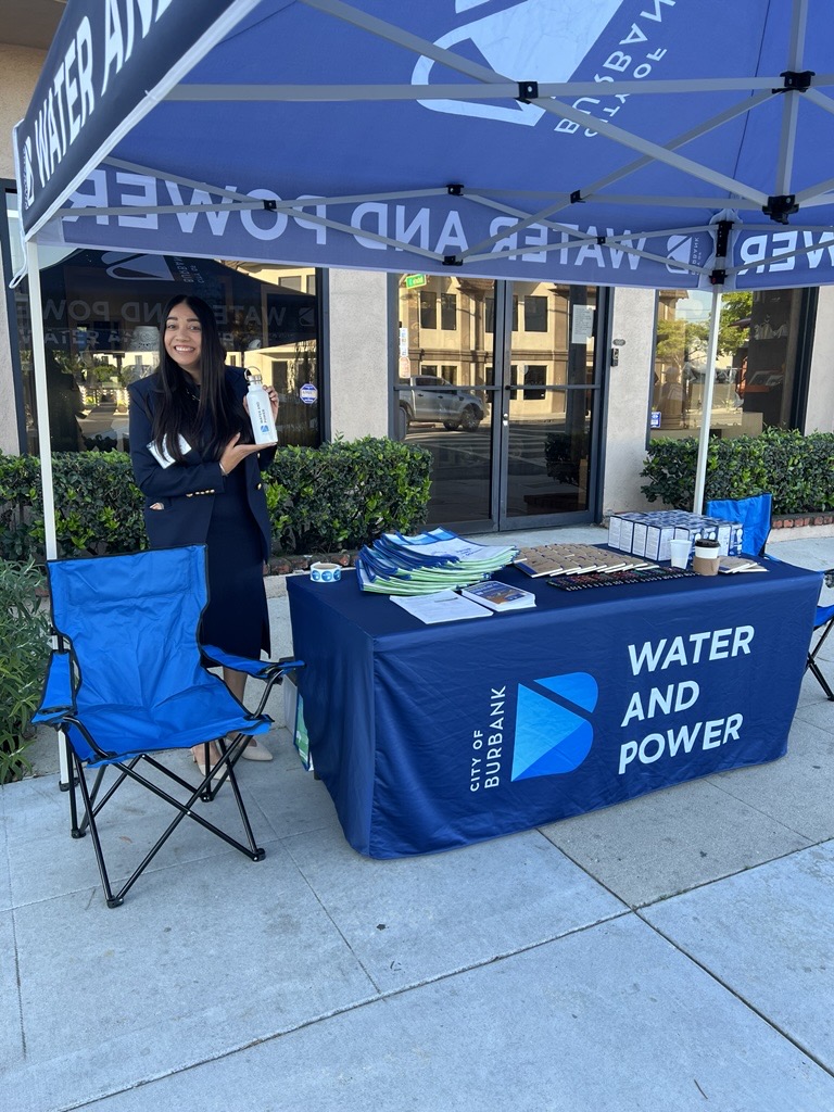Mandip holding a water bottle outside the Ugly Mug